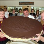 Kirklees College Hospitality and Catering Team Leader Gary Schofield offers Huddersfield Giants players Jacob Fairbank and Aaron Murphy a bite