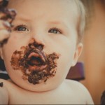 baby with chocolate cake