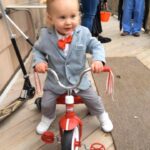 Sarah Dewey Herman Girl as Pee-wee on trike Halloween 2021